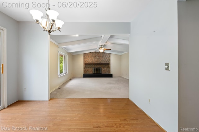 683 Thurber Dr, Troy, MI 48085 - unfurnished living room with a chandelier, a ceiling fan, a brick fireplace, and wood finished floors