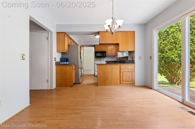 683 Thurber Dr, Troy, MI 48085 - kitchen with electric range, black microwave, light wood-type flooring, dark countertops, and a chandelier