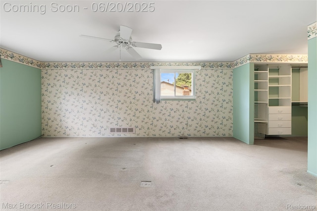 683 Thurber Dr, Troy, MI 48085 - unfurnished bedroom featuring carpet flooring, wallpapered walls, a spacious closet, and a ceiling fan