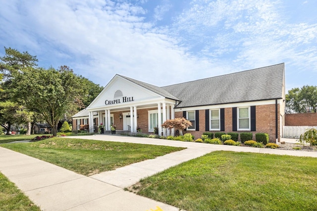 3126 Bolgos Cir, Ann Arbor, MI 48105 - neoclassical home with brick siding, a porch, and a shingled roof