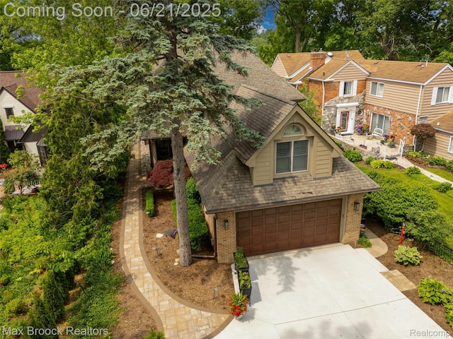 6510 Commerce Rd, West Bloomfield, MI 48324 - view of front of house featuring brick siding, concrete driveway, roof with shingles, and a garage