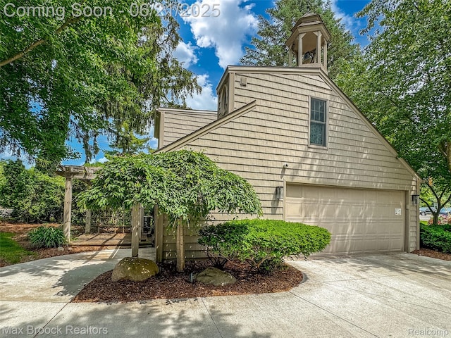 6510 Commerce Rd, West Bloomfield, MI 48324 - view of property exterior with driveway and an attached garage