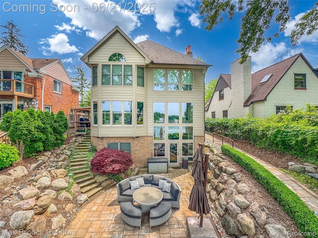 6510 Commerce Rd, West Bloomfield, MI 48324 - rear view of property with stairs, a patio area, and brick siding