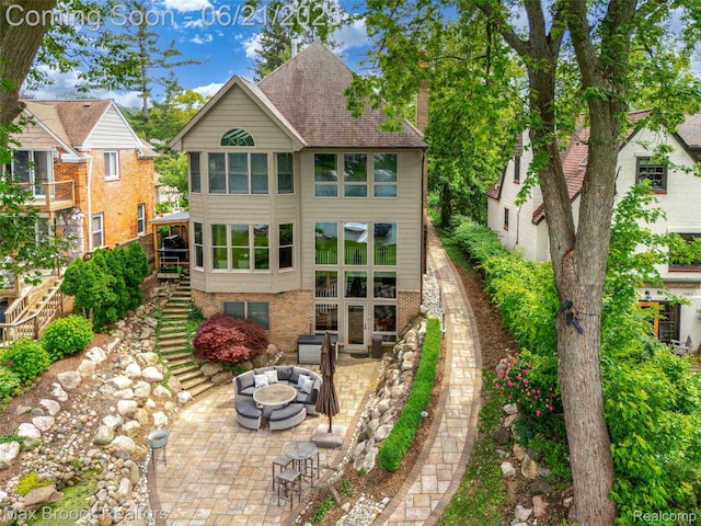 6510 Commerce Rd, West Bloomfield, MI 48324 - back of house with a fire pit, stairway, a patio area, a chimney, and roof with shingles