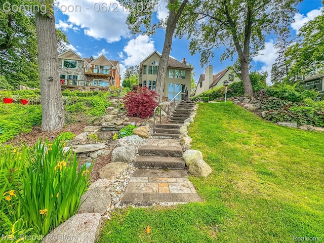 6510 Commerce Rd, West Bloomfield, MI 48324 - back of house featuring stairs and a lawn