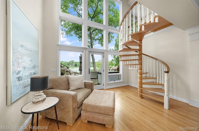 6510 Commerce Rd, West Bloomfield, MI 48324 - living area with stairway, wood finished floors, and a towering ceiling