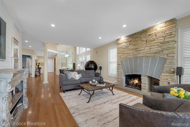 6510 Commerce Rd, West Bloomfield, MI 48324 - living area featuring a fireplace, wood finished floors, and recessed lighting