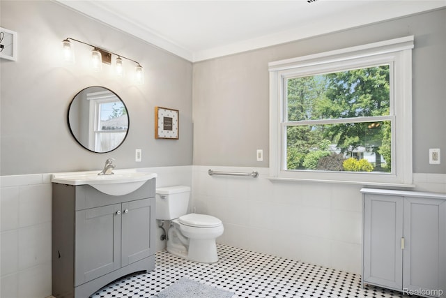 39248 Wade Rd, Taylor, MI 48174 - bathroom with tile walls, wainscoting, vanity, and tile patterned floors