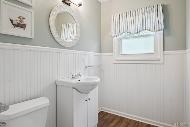 39248 Wade Rd, Taylor, MI 48174 - bathroom featuring a wainscoted wall, wood finished floors, and vanity
