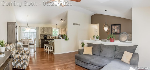 8642 Thendara Blvd, Clarkston, MI 48348 - living area featuring wood finished floors, lofted ceiling, and a chandelier