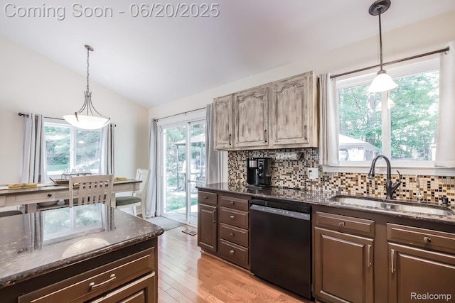 8642 Thendara Blvd, Clarkston, MI 48348 - kitchen with black dishwasher, lofted ceiling, backsplash, dark brown cabinets, and dark stone countertops