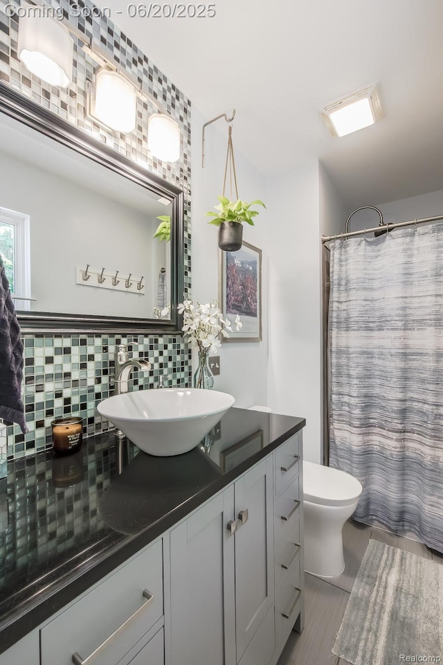 8642 Thendara Blvd, Clarkston, MI 48348 - bathroom featuring backsplash, vanity, and a shower with shower curtain