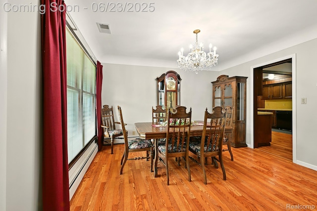 2441 Cheryl Ann Dr, Burton, MI 48519 - dining space with a chandelier, baseboard heating, and light wood-style floors