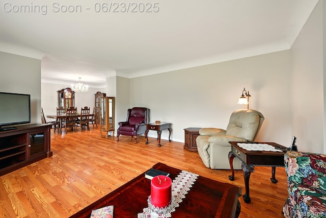 2441 Cheryl Ann Dr, Burton, MI 48519 - living room featuring a chandelier and light wood finished floors