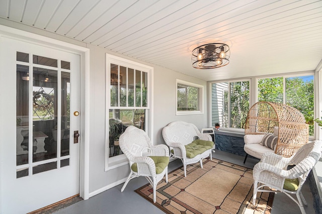 14711 White Creek Ave NE, Cedar Springs, MI 49319 - sunroom / solarium featuring healthy amount of natural light, wooden ceiling, a chandelier, and concrete floors