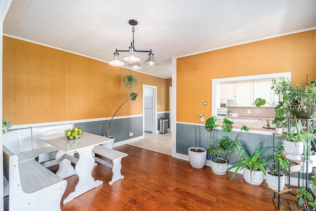 14711 White Creek Ave NE, Cedar Springs, MI 49319 - dining area with crown molding and wood finished floors