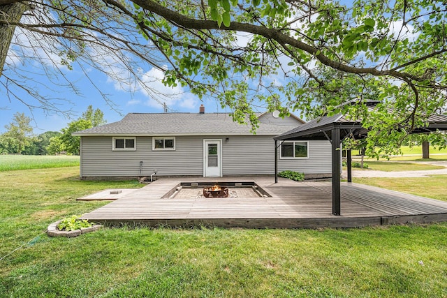 14711 White Creek Ave NE, Cedar Springs, MI 49319 - rear view of house with a deck, a fire pit, a gazebo, and a lawn