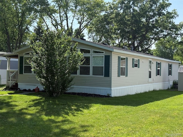 27444 Bordeau Dr, Romulus, MI 48174 - manufactured / mobile home featuring a front yard and entry steps