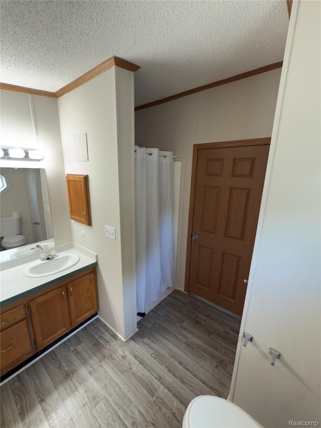 27444 Bordeau Dr, Romulus, MI 48174 - full bath with ornamental molding, wood finished floors, vanity, a textured ceiling, and curtained shower