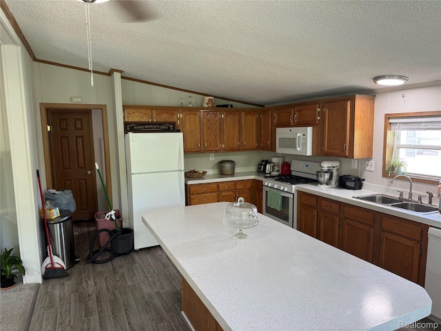 27444 Bordeau Dr, Romulus, MI 48174 - kitchen featuring white appliances, lofted ceiling, a textured ceiling, dark wood finished floors, and brown cabinets