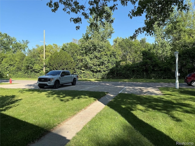 27444 Bordeau Dr, Romulus, MI 48174 - view of green lawn featuring a forest view