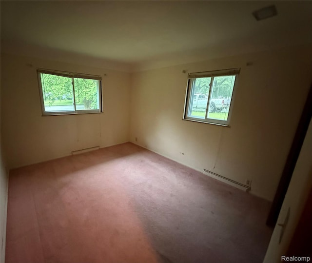 906 W Burnside St, Caro, MI 48723 - unfurnished room with a baseboard radiator, healthy amount of natural light, and carpet floors