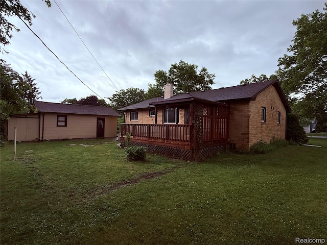 906 W Burnside St, Caro, MI 48723 - back of house featuring a wooden deck, a lawn, a chimney, and brick siding