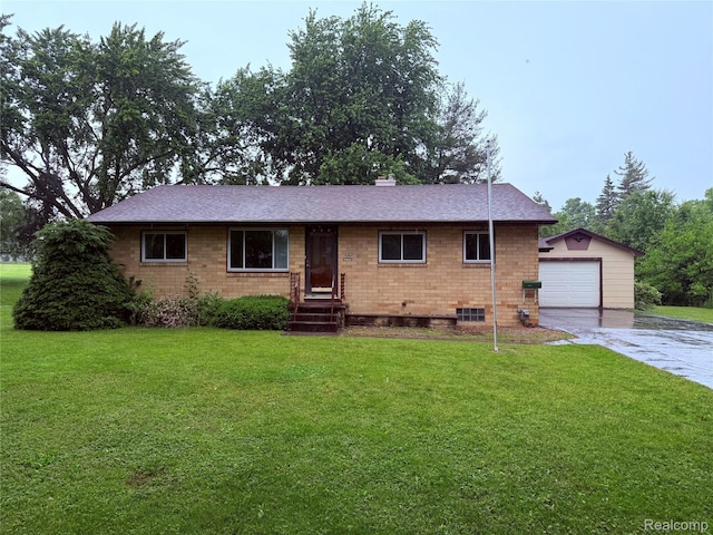 906 W Burnside St, Caro, MI 48723 - single story home featuring concrete driveway, an outbuilding, a front lawn, a detached garage, and a shingled roof