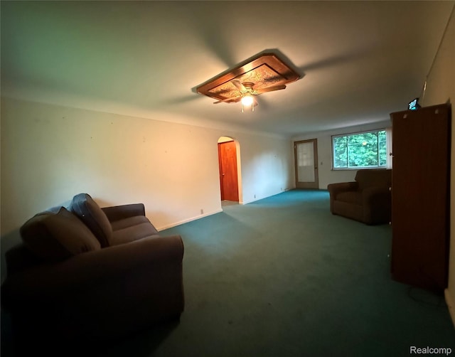 906 W Burnside St, Caro, MI 48723 - living area with arched walkways, a ceiling fan, and carpet floors