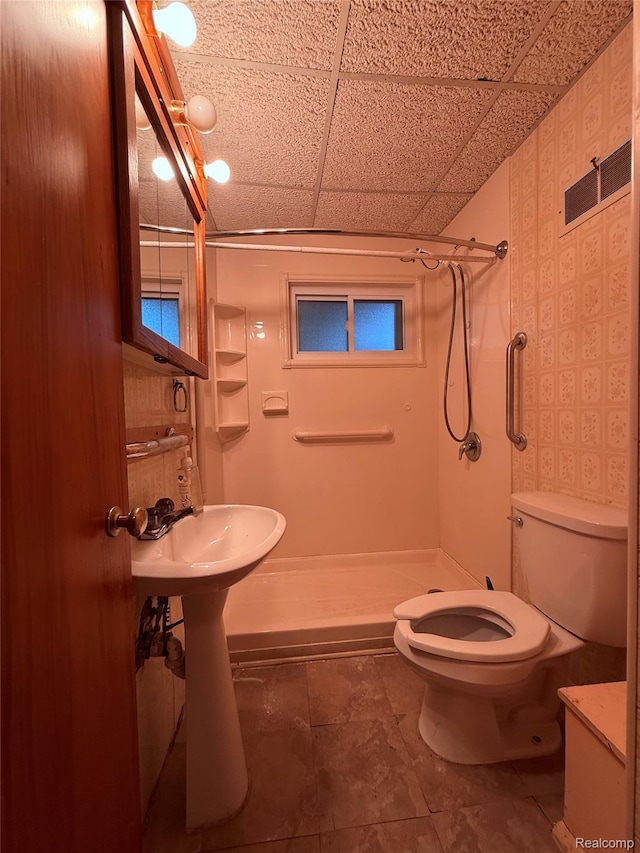 906 W Burnside St, Caro, MI 48723 - bathroom featuring a shower stall, a drop ceiling, and tile patterned flooring