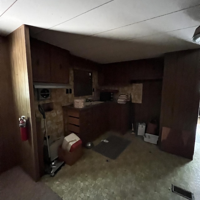 6539 Mattis Dr, Glennie, MI 48737 - kitchen with wood walls and carpet floors