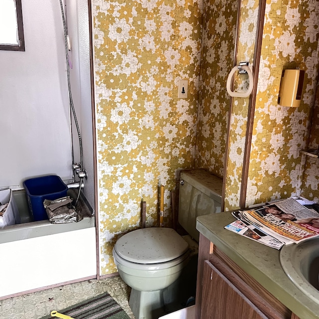 6539 Mattis Dr, Glennie, MI 48737 - bathroom with wallpapered walls, vanity, and a tub