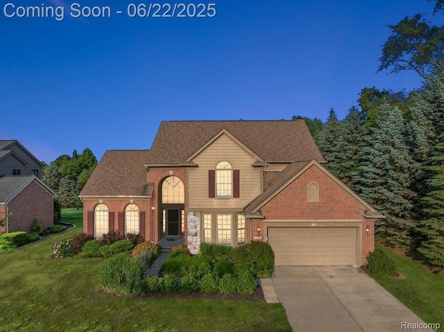 11700 Currin Ct, Plymouth, MI 48170 - traditional home featuring a front yard, driveway, brick siding, and an attached garage