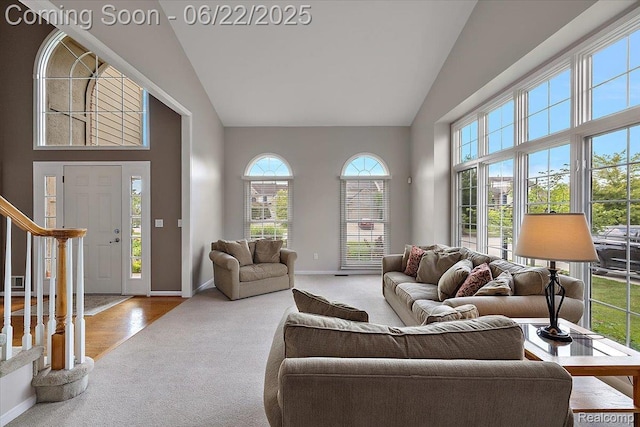 11700 Currin Ct, Plymouth, MI 48170 - carpeted living room featuring high vaulted ceiling and stairway