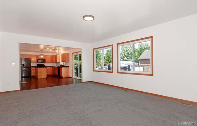 28475 Tiffin Dr, Chesterfield, MI 48047 - unfurnished living room with a chandelier and dark carpet