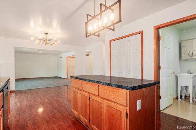 28475 Tiffin Dr, Chesterfield, MI 48047 - kitchen featuring a chandelier, dark wood-style floors, stainless steel dishwasher, dark countertops, and a center island
