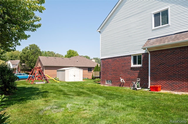 28475 Tiffin Dr, Chesterfield, MI 48047 - view of green lawn featuring a storage unit and a playground