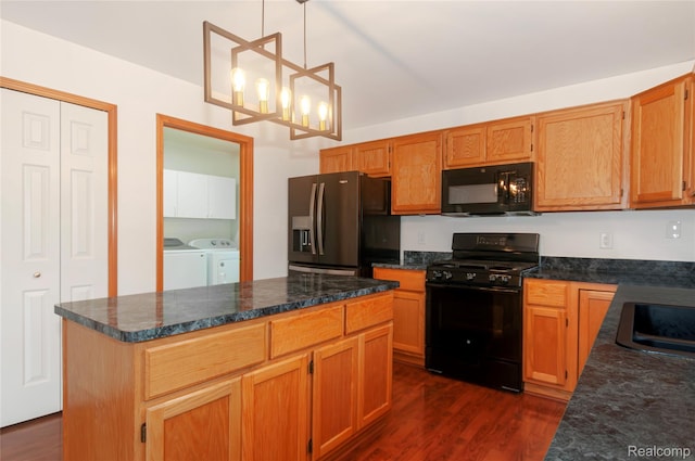 28475 Tiffin Dr, Chesterfield, MI 48047 - kitchen with black appliances, washer and clothes dryer, dark wood-type flooring, a center island, and decorative light fixtures