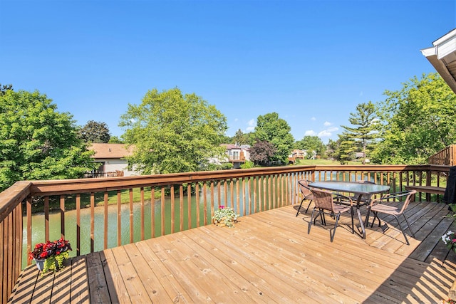5049 Stauffer Ave SE, Grand Rapids, MI 49508 - deck with outdoor dining area and a lawn