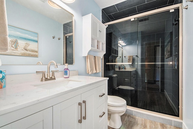 5049 Stauffer Ave SE, Grand Rapids, MI 49508 - full bathroom featuring vanity, a stall shower, and wood finished floors