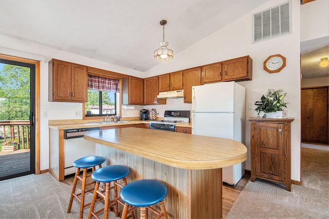5049 Stauffer Ave SE, Grand Rapids, MI 49508 - kitchen featuring white appliances, under cabinet range hood, light countertops, vaulted ceiling, and a breakfast bar area