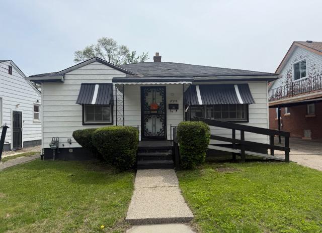 18908 Mackay St, Detroit, MI 48234 - bungalow-style house featuring a front yard and a chimney
