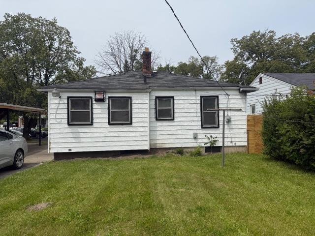 18908 Mackay St, Detroit, MI 48234 - back of property featuring a yard and a chimney