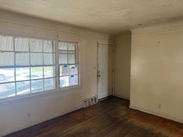 18908 Mackay St, Detroit, MI 48234 - unfurnished room with dark wood finished floors and a textured ceiling