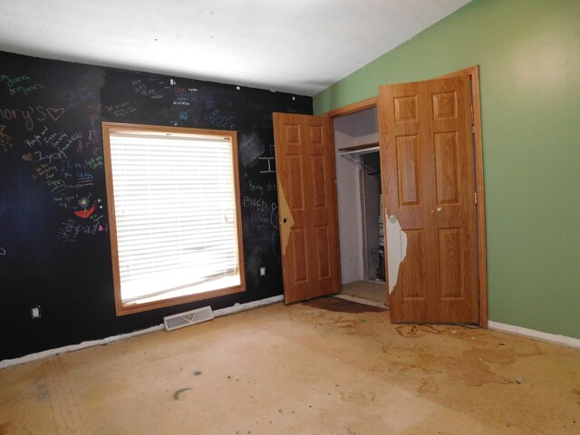 1240 Abbey Ln, Mount Pleasant, MI 48858 - unfurnished bedroom featuring multiple windows and lofted ceiling