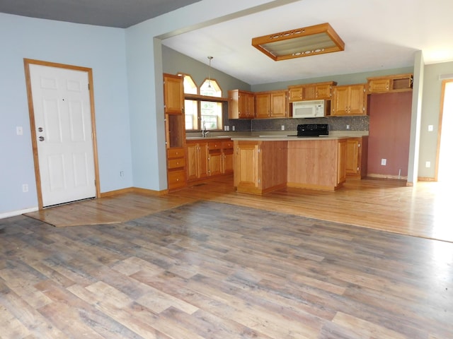 1240 Abbey Ln, Mount Pleasant, MI 48858 - kitchen featuring white microwave, stove, light countertops, and light wood finished floors