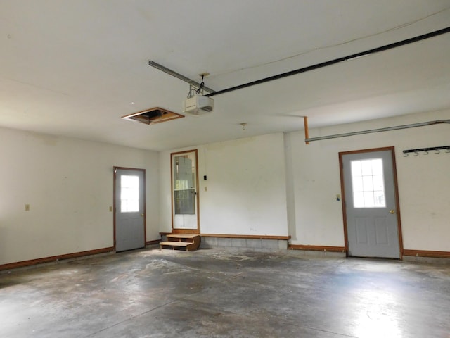 1240 Abbey Ln, Mount Pleasant, MI 48858 - garage featuring a garage door opener and baseboards