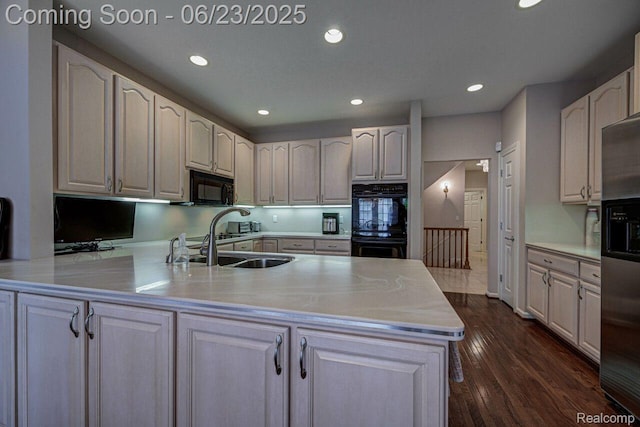 1081 Park Place Ct, Bloomfield Hills, MI 48302 - kitchen with black appliances, a peninsula, recessed lighting, light countertops, and dark wood-type flooring