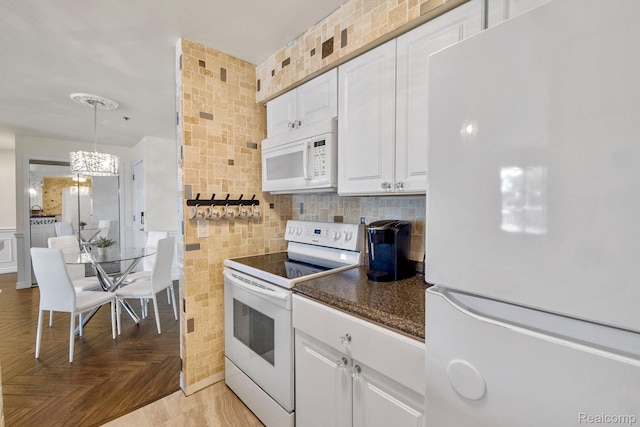 37510 Jefferson Unit 203, Harrison Township, MI 48045 - kitchen with white appliances, white cabinets, a chandelier, tile walls, and hanging light fixtures