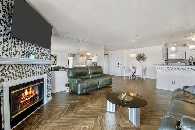 37510 Jefferson Unit 203, Harrison Township, MI 48045 - living area featuring a wainscoted wall, wallpapered walls, and a fireplace